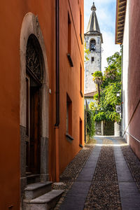 An alley in locarno historic center with the tower bell of s. maria assunta church, switzerland