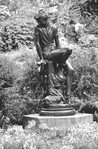 Statue of woman in pond