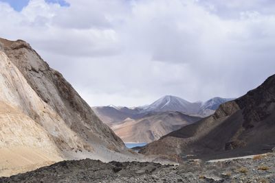 Scenic view of mountains against cloudy sky