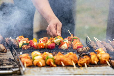 Close-up of a man making chicken shish kebab barbecue