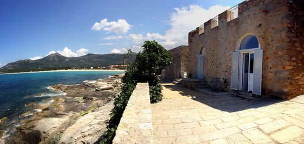 Panoramic view of sea and buildings against sky