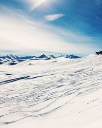 Snow covered landscape against sky