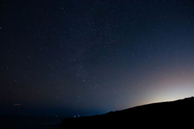 Low angle view of mountain against sky at night