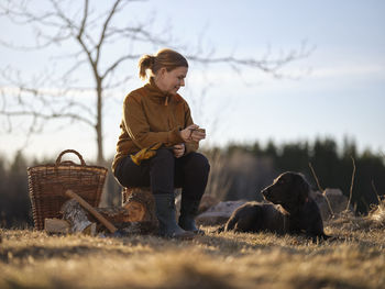 Woman and dog taking break from outdoor work