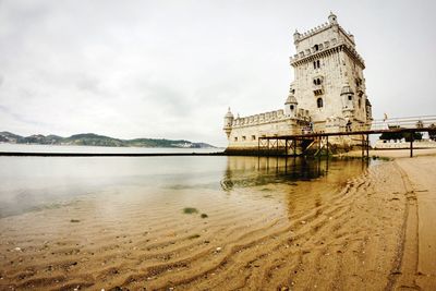 Low angle view of belem tower at riverbank