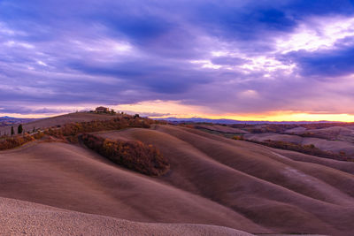 Scenic view of desert against sky during sunset