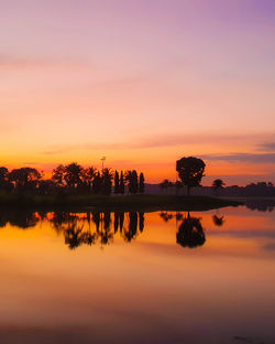 Scenic view of lake against romantic sky at sunset