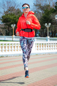 Portrait of young woman standing on street