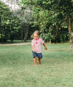 Full length of cute girl standing on field