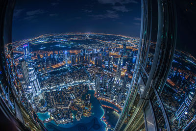 High angle view of illuminated modern buildings in city at night