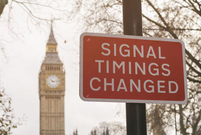 Close-up of road sign against trees