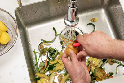 Cropped hand of person preparing food