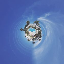 Digital composite image of clock on building against sky