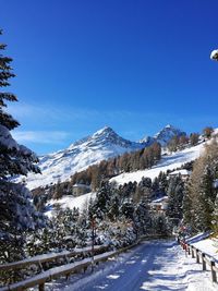 Scenic view of swiss alps against clear blue sky during winter