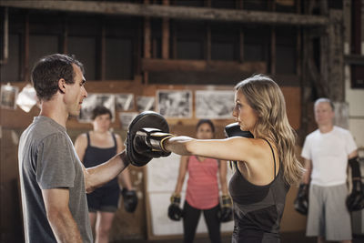 Confident boxers practicing in health club