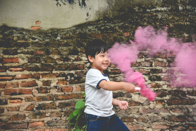 Portrait of happy boy with smoke bomb