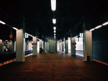Empty corridor of illuminated building