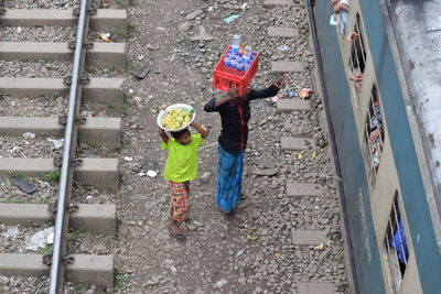 High angle view of vendors selling food and drink while standing by train