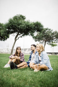 Woman sitting on lawn at park