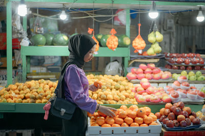 Rear view of fruits for sale at market stall