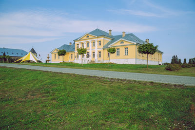 Houses on field against sky