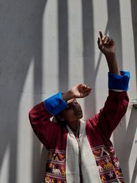 Young couple standing against wall