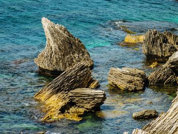 High angle view of rocks in sea