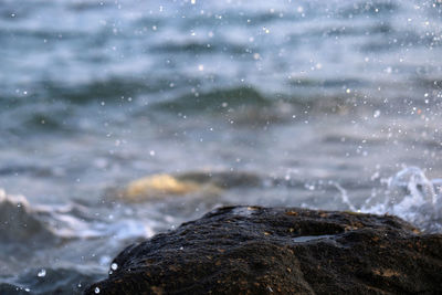 Close-up of sea waves splashing on rocks