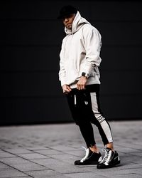 Full length of man standing on footpath against wall