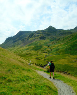 Rear view of man walking on mountain