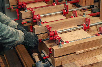 Carpenter's hands clamp board. wood processing.