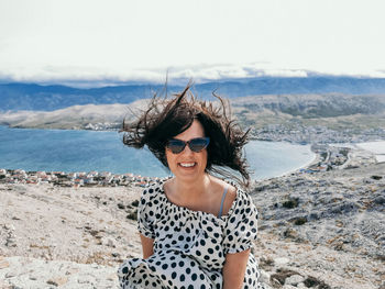 Portrait of smiling young woman on beach