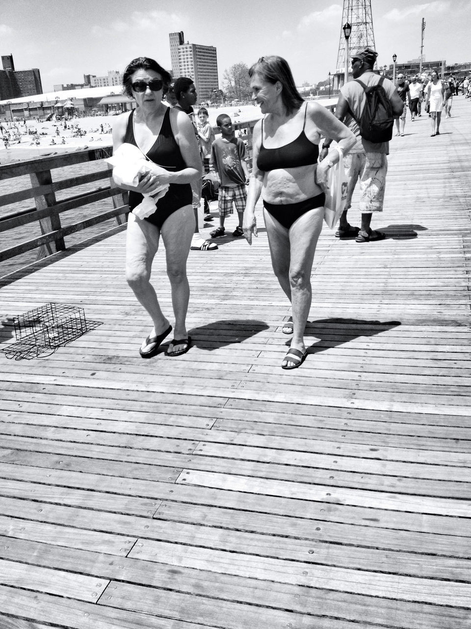 lifestyles, leisure activity, full length, men, walking, casual clothing, person, togetherness, rear view, large group of people, railing, boys, built structure, childhood, day, steps, wood - material, sky