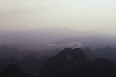 Scenic view of silhouette mountains against sky during sunset