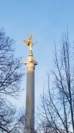 Low angle view of bare tree against sky
