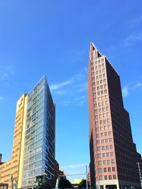 Low angle view of modern building against blue sky