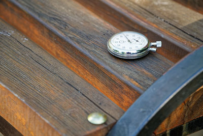 High angle view of stopwatch on bench