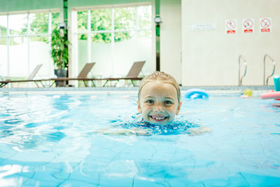 Portrait of boy swimming in pool