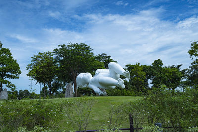 Statue in park against sky