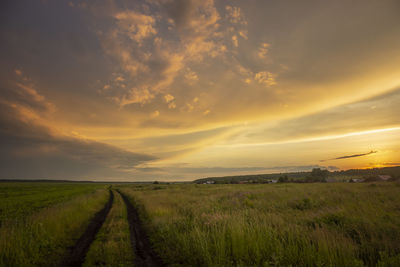 Scenic view of field against sky during sunset