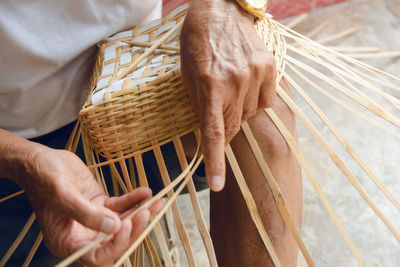 Close-up of man working in basket