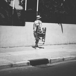 Full length of woman standing by railing