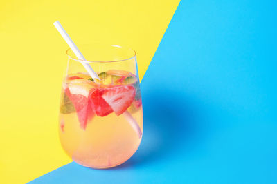 Close-up of drink in glass against blue background