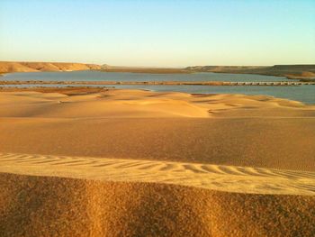 Scenic view of beach against clear sky