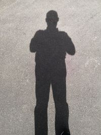 Shadow of person on street in city