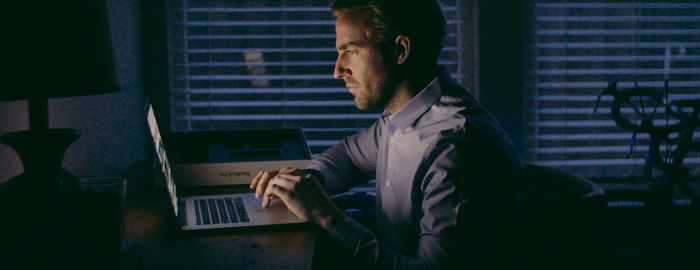 Man using laptop on table at home