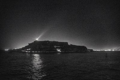 Scenic view of sea against sky at night