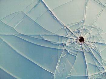 Close-up of bullet hole on glass window