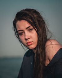 Portrait of beautiful woman against sky