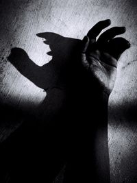 High angle view of shadow on hand